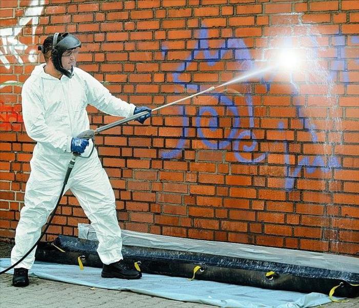 What should you do before you remove graffiti?