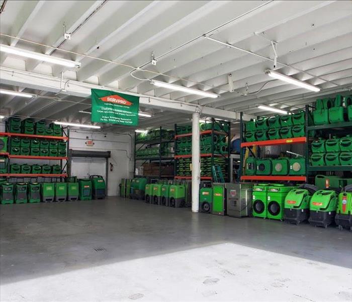 Facility stocked full of green dehumidifiers, air movers, and air scrubbers.